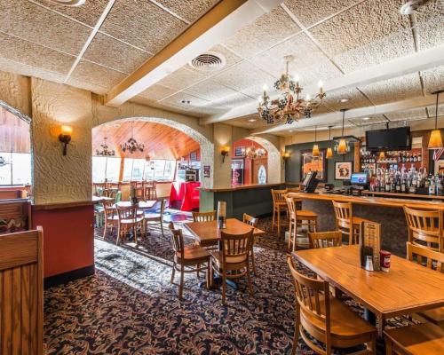 a restaurant with tables and chairs and a bar at Quality Inn & Suites Conference Center Across from Casino in Erie