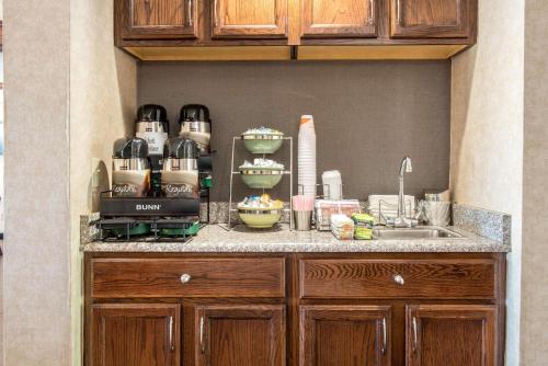 a kitchen with a counter top with a sink and a counter top at Quality Inn Meadville in Meadville