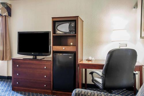 a hotel room with a desk with a television and a chair at Comfort Inn Feasterville - Trevose in Trevose