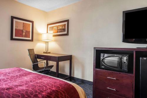 a hotel room with a bed and a desk and a tv at Comfort Inn Feasterville - Trevose in Trevose
