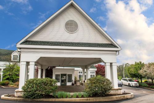 a white church with a gambrel roof at Quality Inn Pittsburgh Airport in Oakdale