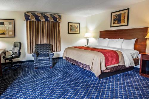 a hotel room with a bed and a chair at Comfort Inn Feasterville - Trevose in Trevose