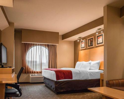 a hotel room with a bed and a window at Comfort Suites Monroeville - Pittsburgh East in Monroeville