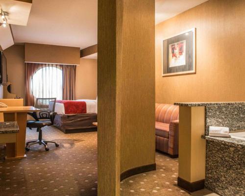 a hotel room with a bed and a desk at Comfort Suites Monroeville - Pittsburgh East in Monroeville