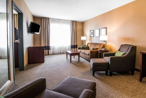 a hotel room with a couch and chairs and a tv at Quality Inn & Suites Towanda in Towanda