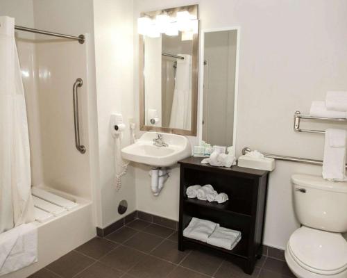 a bathroom with a sink and a toilet and a shower at Sleep Inn & Suites Harrisburg - Hershey North in Harrisburg