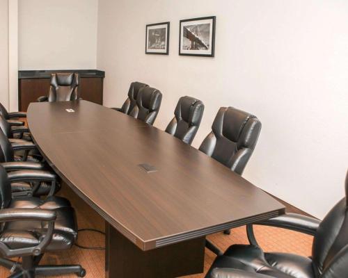a conference room with a wooden table and chairs at Sleep Inn & Suites Harrisburg - Hershey North in Harrisburg
