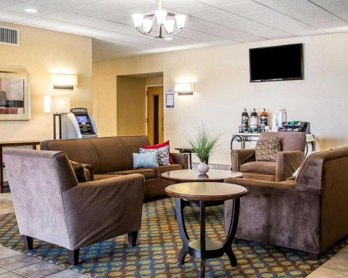 a waiting room with couches and a table at Wilkes-Barre Inn & Suites in Wilkes-Barre