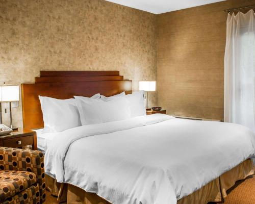 a large white bed in a hotel room at The Woodlands Inn in Wilkes-Barre
