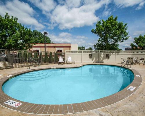 a large swimming pool with a patio and a building at Quality Inn & Suites NJ State Capital Area in Morrisville