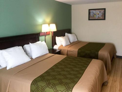 a hotel room with two beds and two lamps at Econo Lodge Harrisburg - Hershey in Harrisburg