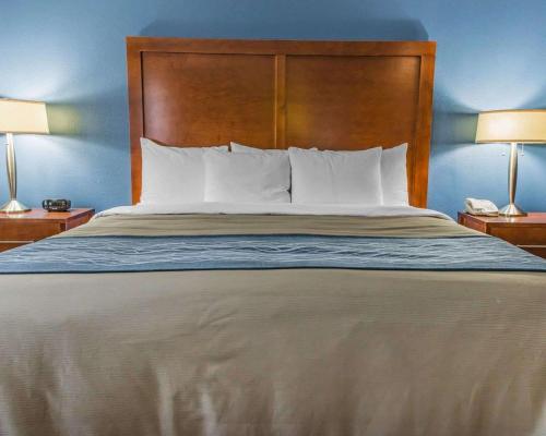a bed with a white bedspread and pillows at Comfort Inn Belle Vernon in Belle Vernon