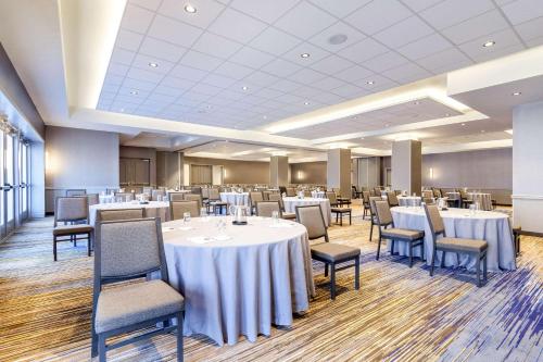 a banquet room with white tables and chairs at Cambria Hotel Pittsburgh - Downtown in Pittsburgh
