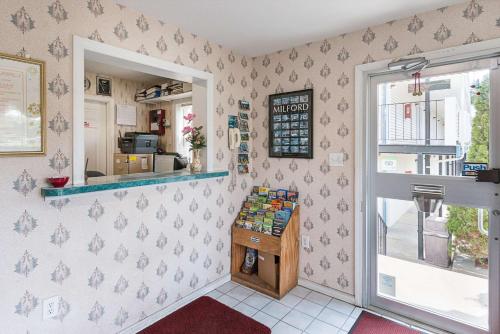 a room with a counter and a window at Rodeway Inn Milford - I-84 in Milford