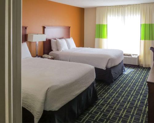 a hotel room with two beds and a window at Quality Inn Cranberry Township in Cranberry Township