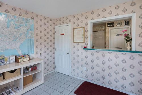 a kitchen with a map of the world on the wall at Rodeway Inn Milford - I-84 in Milford