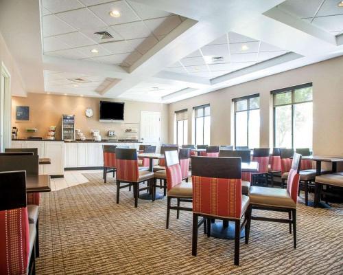 a conference room with tables and chairs and a kitchen at Comfort Suites West Warwick - Providence in West Warwick