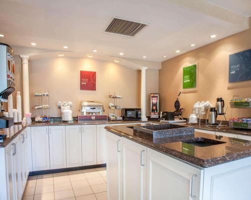 a large kitchen with white counter tops in a restaurant at Comfort Suites West Warwick - Providence in West Warwick
