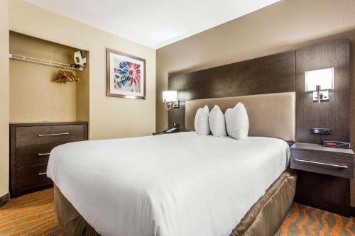 a large white bed in a hotel room at MainStay Suites Greenville Airport in Greer