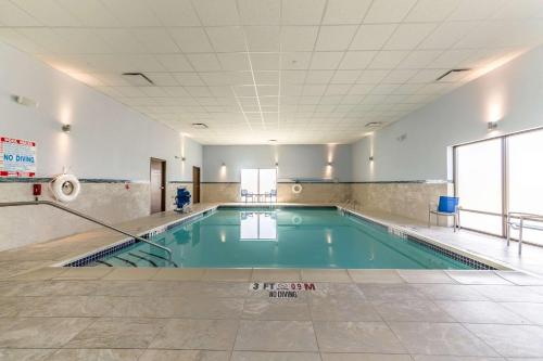an empty swimming pool in a building with a tile floor at Allentown Park Hotel, Ascend Hotel Collection in Allentown
