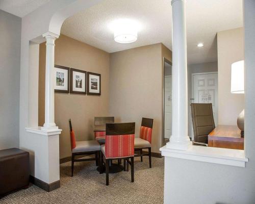 a dining room with chairs and a table in a room at Comfort Suites West Warwick - Providence in West Warwick
