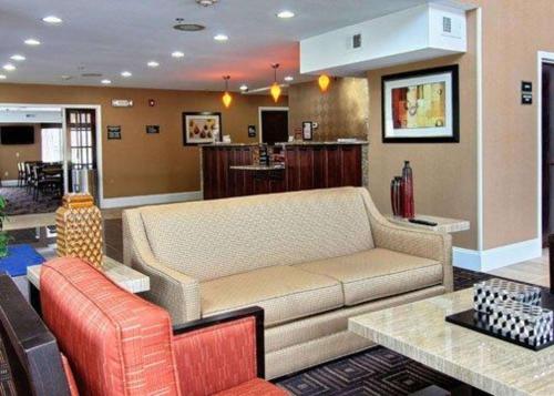 a living room with a couch and a table at Quality Inn & Suites Greenville near downtown in Greenville