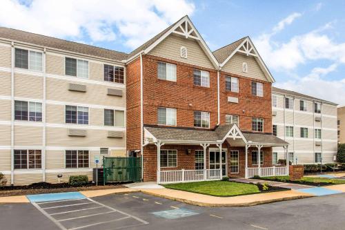 an apartment building with a parking lot in front of it at MainStay Suites Greenville Airport in Greer