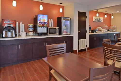 a dining room with a table and a counter at Sleep Inn Beaufort near MCAS in Beaufort