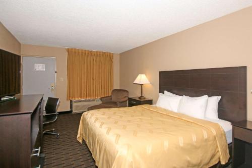 a hotel room with a bed and a television at Quality Inn Clinton - Laurens I-26 in Clinton