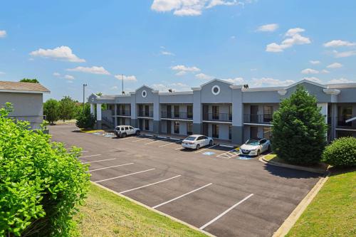 a hotel with cars parked in a parking lot at Quality Inn & Suites Greenville - Haywood Mall in Greenville
