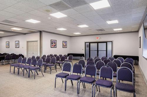 a room with chairs and a screen in it at Quality Inn & Suites Greenville - Haywood Mall in Greenville