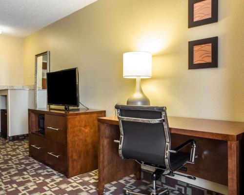 a room with a desk with a chair and a television at Comfort Inn & Suites Walterboro I-95 in Walterboro