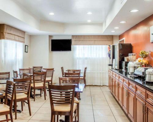 a restaurant with a table and chairs and a kitchen at Sleep Inn North Charleston Ashley Phosphate in Charleston