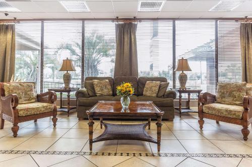 a living room with couches and chairs and a table at Quality Inn & Suites Georgetown in Georgetown