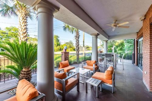a porch with orange furniture and a palm tree at Holiday Inn Express & Suites Lexington, an IHG Hotel in Lexington