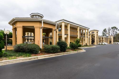 a large building with a street in front of it at Suburban Studios Florence I-95 in Florence