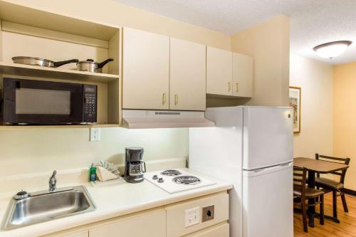 a kitchen with a white refrigerator and a sink at Studio 6 Myrtle Beach, SC in Myrtle Beach