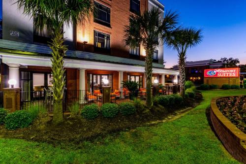 a hotel with palm trees in front of a building at Holiday Inn Express & Suites Lexington, an IHG Hotel in Lexington