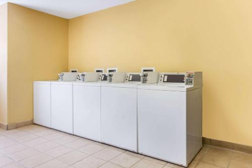 a row of white washing machines in a room at Studio 6 Myrtle Beach, SC in Myrtle Beach