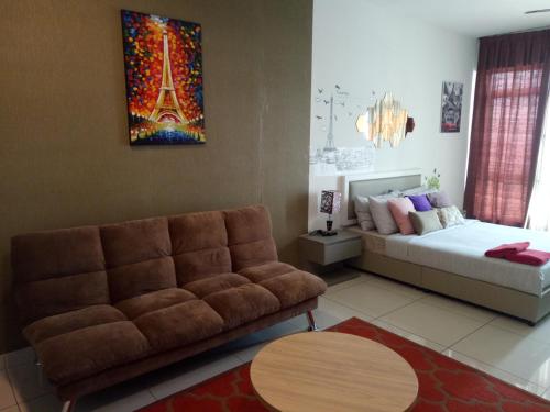 a living room with a couch and a bed at Bangi Studio Suite - Netflix in Kampong Sungai Ramal Dalam
