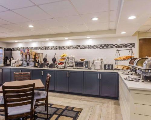 a kitchen with blue cabinets and a table and chairs at Quality Inn Mt Pleasant - Charleston in Charleston