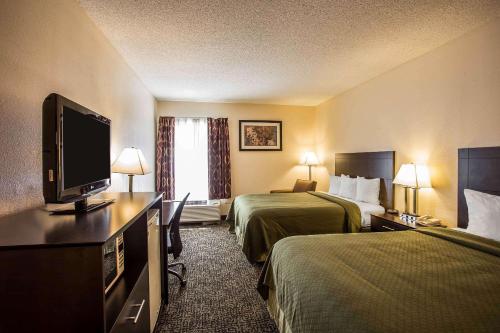 a hotel room with two beds and a flat screen tv at Quality Inn Union US Hwy 176 in Union