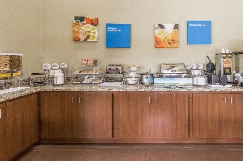 a kitchen with a counter with food on it at Comfort Inn & Suites Greenwood near University in Greenwood