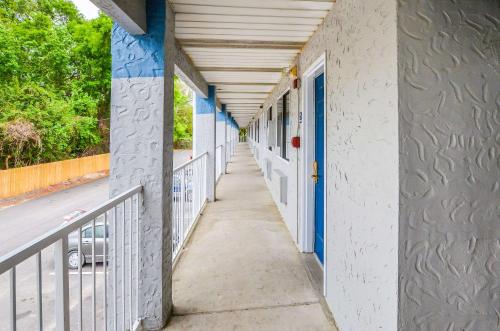 a corridor of a building with blue and white walls at Rodeway Inn North Charleston - Ashley Phosphate in Charleston
