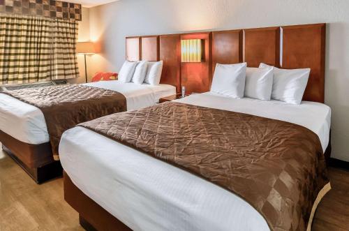 a hotel room with two beds and a window at Rodeway Inn North Charleston in Charleston