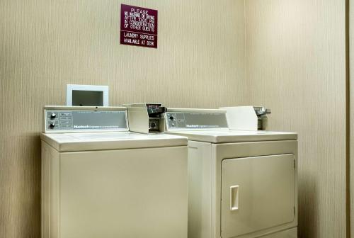 two washing machines and a washer and dryer in a room at EverSpring Inn & Suites in Hill City