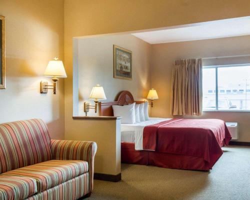 A bed or beds in a room at Quality Inn Brookings-University