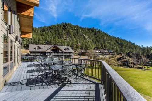 a balcony with tables and chairs and a mountain at K Bar S Lodge, Ascend Hotel Collection in Keystone