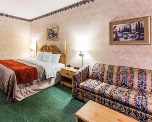 a hotel room with a bed and a couch at Econo Lodge Newport West in Newport