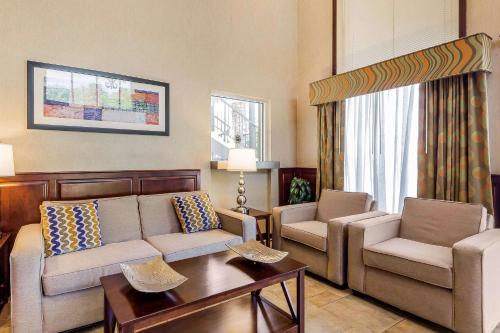 a living room with a couch and two chairs and a table at Quality Inn & Suites Sevierville - Pigeon Forge in Sevierville